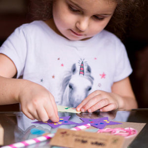 A child making an eco friendly craft kit at a birthday party